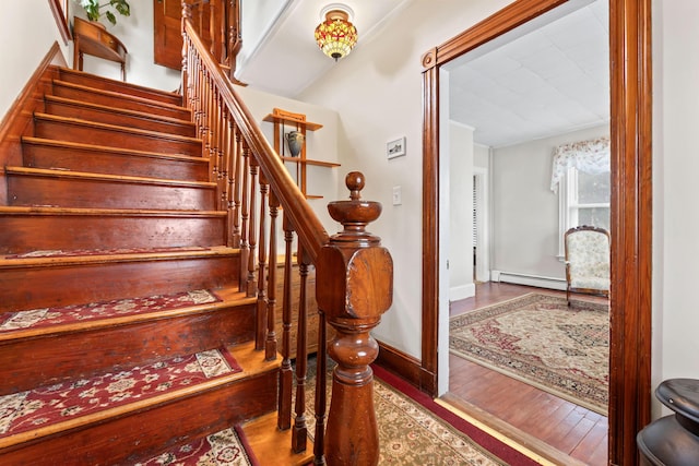 10 Hollingsworth St, Winslow, ME 04901 - staircase featuring wood finished floors, a baseboard heating unit, and baseboards