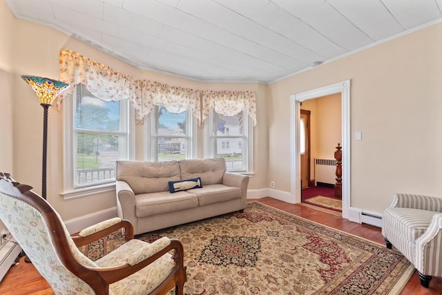 10 Hollingsworth St, Winslow, ME 04901 - living room with radiator, wood finished floors, ornamental molding, a baseboard heating unit, and baseboards