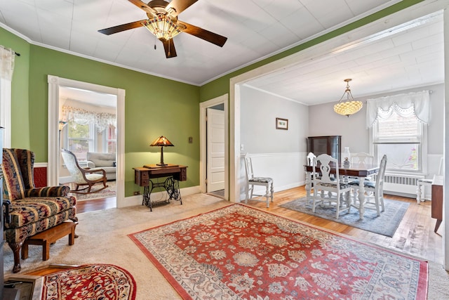 10 Hollingsworth St, Winslow, ME 04901 - dining room featuring plenty of natural light, crown molding, a ceiling fan, radiator heating unit, and wood finished floors