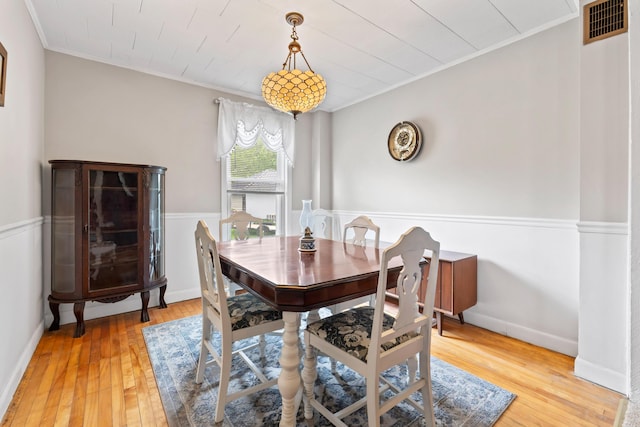 10 Hollingsworth St, Winslow, ME 04901 - dining room with ornamental molding, light wood-style floors, and a wainscoted wall
