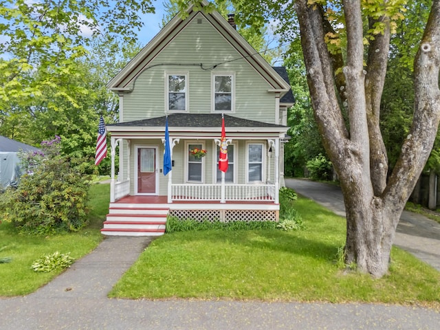 10 Hollingsworth St, Winslow, ME 04901 - view of front of property featuring a porch, a front yard, and a shingled roof