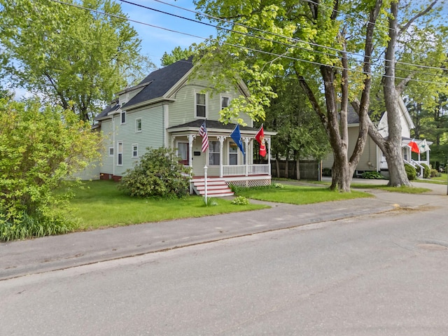 10 Hollingsworth St, Winslow, ME 04901 - victorian-style house featuring a porch, a front yard, and a shingled roof