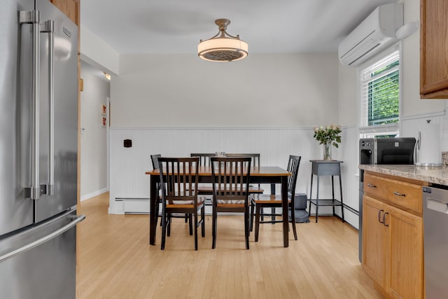 6 Goff Ave, Lewiston, ME 04240 - dining area with a wall unit AC, light wood-style floors, a wainscoted wall, and a baseboard heating unit