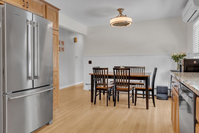 6 Goff Ave, Lewiston, ME 04240 - dining area featuring a wall mounted AC, light wood finished floors, and a wainscoted wall