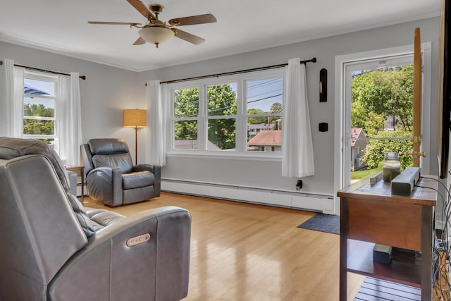 6 Goff Ave, Lewiston, ME 04240 - living area featuring baseboard heating, plenty of natural light, light wood finished floors, and crown molding