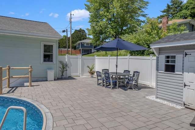 6 Goff Ave, Lewiston, ME 04240 - fenced backyard with a patio area, outdoor dining space, and an outbuilding