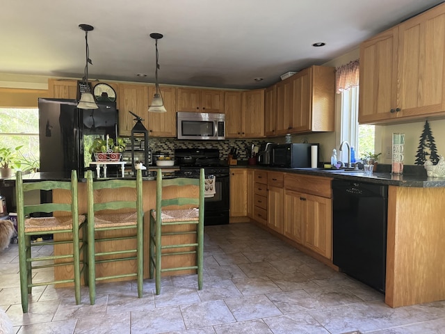 40 Justin Ln, Hermon, ME 04401 - kitchen with black appliances, dark countertops, a sink, light stone finish flooring, and decorative backsplash