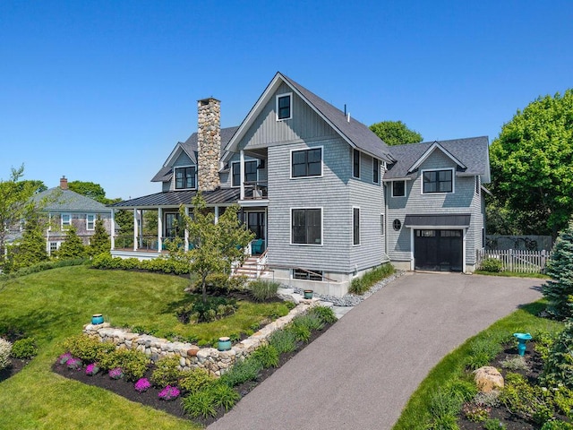 7 First St, Biddeford, ME 04006 - view of front facade with a standing seam roof, an attached garage, a chimney, driveway, and metal roof