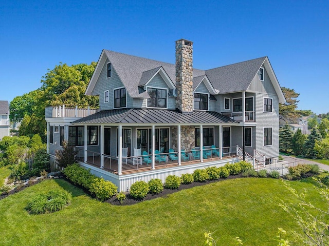 7 First St, Biddeford, ME 04006 - back of property featuring a standing seam roof, a yard, a chimney, a shingled roof, and metal roof