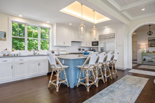 7 First St, Biddeford, ME 04006 - kitchen featuring a sink, white cabinetry, built in appliances, a kitchen island, and recessed lighting