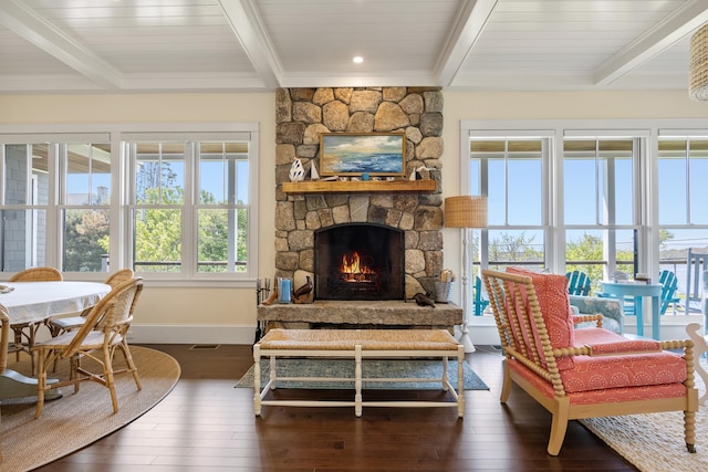 7 First St, Biddeford, ME 04006 - living area featuring beam ceiling, dark wood-type flooring, baseboards, and a stone fireplace