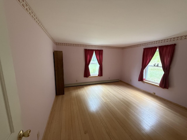 156 Lakeshore Dr, Leeds, ME 04263 - spare room with baseboard heating, plenty of natural light, and light wood-type flooring