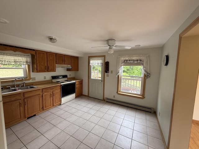 156 Lakeshore Dr, Leeds, ME 04263 - kitchen with white range with electric cooktop, a baseboard radiator, under cabinet range hood, a sink, and plenty of natural light