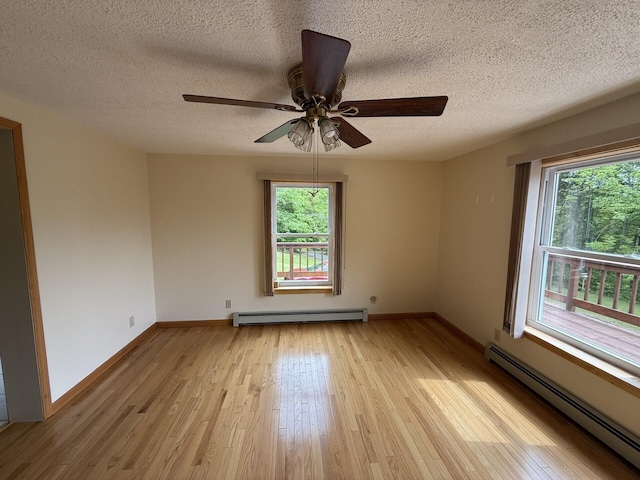 156 Lakeshore Dr, Leeds, ME 04263 - spare room with a baseboard heating unit, light wood-type flooring, a textured ceiling, ceiling fan, and baseboards