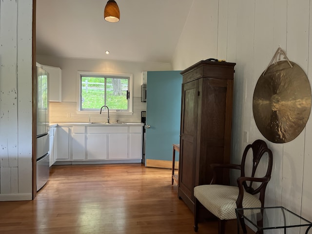 170 Molyneaux Rd, Camden, ME 04843 - kitchen featuring a sink, light wood-style floors, backsplash, light countertops, and vaulted ceiling