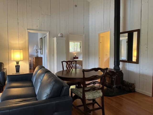 170 Molyneaux Rd, Camden, ME 04843 - dining space featuring wood finished floors, wooden walls, a wood stove, and baseboards