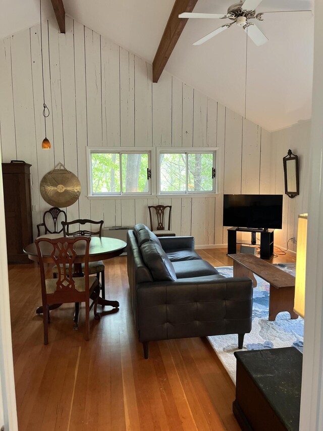 170 Molyneaux Rd, Camden, ME 04843 - living area with hardwood / wood-style flooring, beam ceiling, plenty of natural light, ceiling fan, and wooden walls