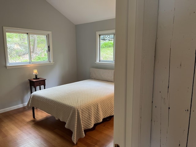 170 Molyneaux Rd, Camden, ME 04843 - bedroom featuring lofted ceiling, wood finished floors, multiple windows, and baseboards