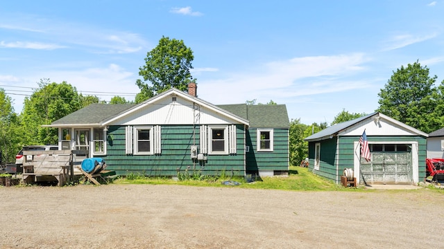 54 Middle Rd, Augusta, ME 04330 - view of front of house with a chimney, an outdoor structure, and a garage