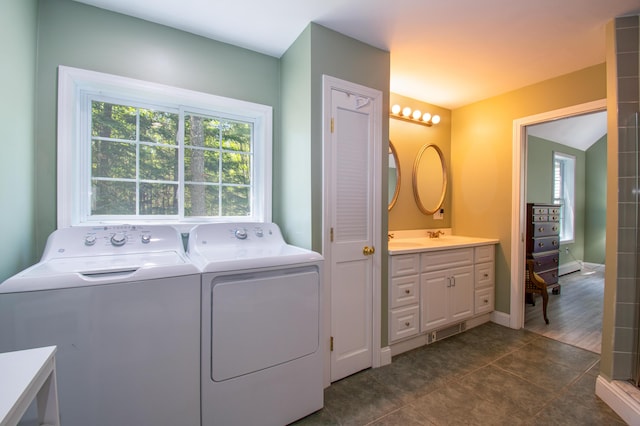 12 Hixon Hill Dr, Woolwich, ME 04579 - laundry room featuring washer and clothes dryer, healthy amount of natural light, and dark tile patterned floors