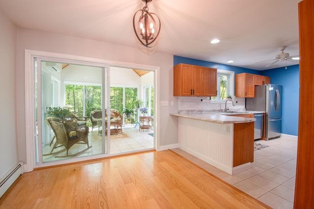 12 Hixon Hill Dr, Woolwich, ME 04579 - kitchen with baseboard heating, light countertops, stainless steel appliances, decorative backsplash, and a peninsula