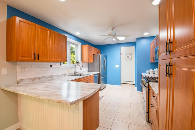 12 Hixon Hill Dr, Woolwich, ME 04579 - kitchen with appliances with stainless steel finishes, a peninsula, light countertops, backsplash, and a ceiling fan