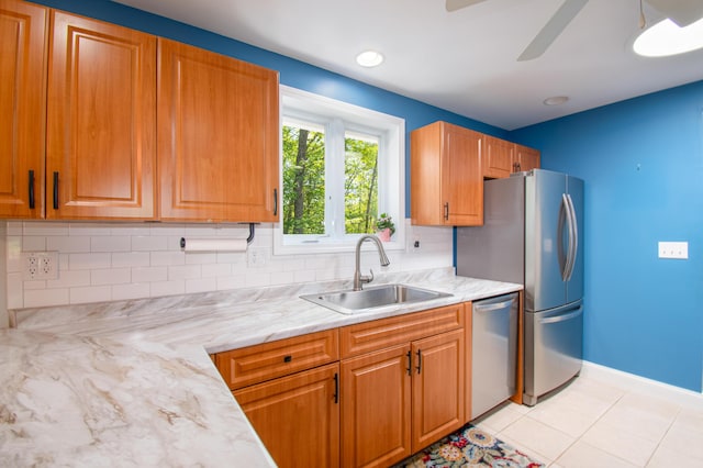 12 Hixon Hill Dr, Woolwich, ME 04579 - kitchen with stainless steel appliances, ceiling fan, tasteful backsplash, light tile patterned flooring, and brown cabinets