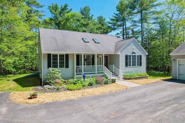 12 Hixon Hill Dr, Woolwich, ME 04579 - view of front of home featuring a porch, a garage, and a shingled roof