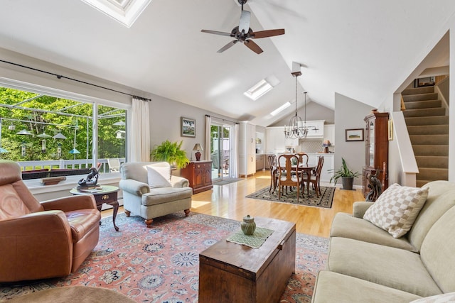 3 Blueberry Rd Unit 3, Yarmouth, ME 04096 - living area featuring light wood-style floors, a chandelier, lofted ceiling, plenty of natural light, and a ceiling fan
