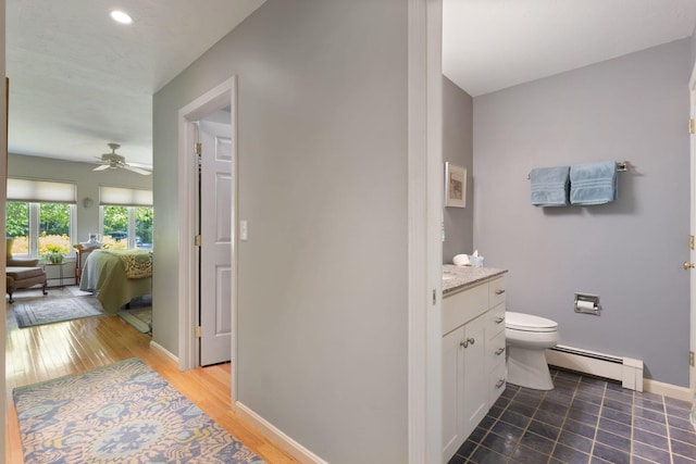 3 Blueberry Rd Unit 3, Yarmouth, ME 04096 - bathroom featuring a baseboard radiator, vanity, a ceiling fan, baseboards, and toilet