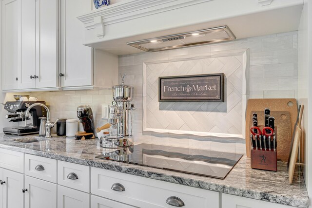 18 Forecaster Way, Scarborough, ME 04074 - kitchen featuring black electric cooktop, white cabinetry, a sink, and decorative backsplash