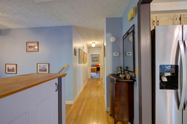 40 Sanborn St, Gorham, ME 04038 - hall with a textured ceiling, light wood-type flooring, baseboards, and an upstairs landing