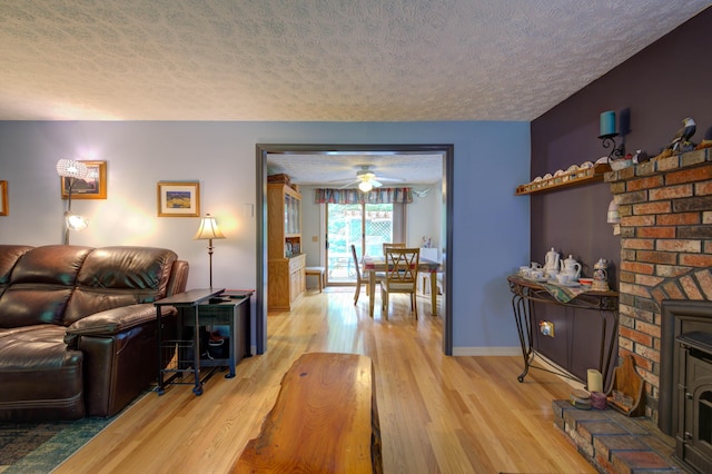 40 Sanborn St, Gorham, ME 04038 - living area with a textured ceiling, light wood-type flooring, ceiling fan, and baseboards