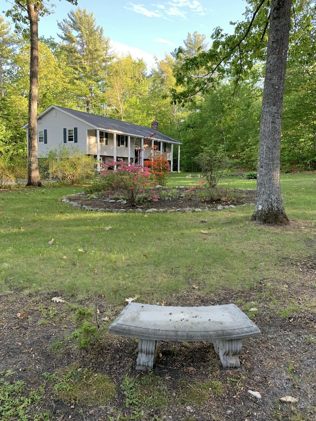 40 Sanborn St, Gorham, ME 04038 - view of front of house featuring a chimney, a porch, and a front lawn