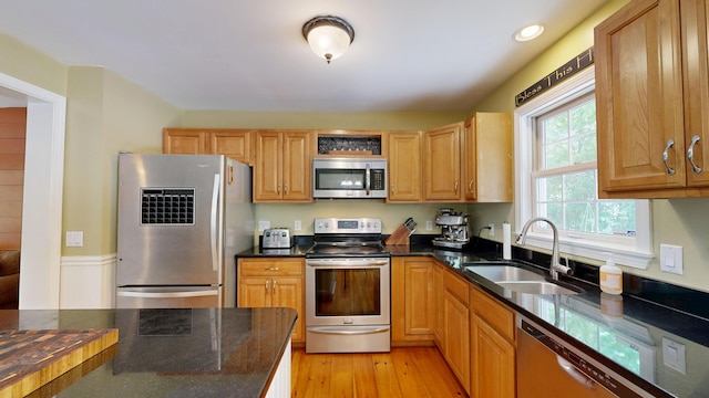 471 Owls Nest Rd, Shapleigh, ME 04076 - kitchen featuring appliances with stainless steel finishes, a sink, dark stone counters, light wood finished floors, and recessed lighting