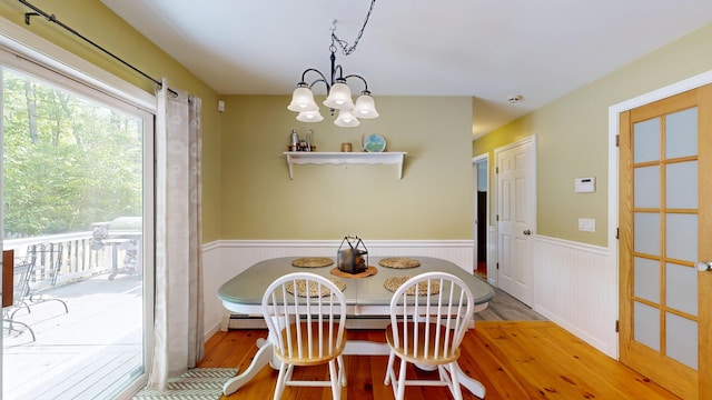 471 Owls Nest Rd, Shapleigh, ME 04076 - dining space with light wood finished floors, wainscoting, breakfast area, and a chandelier