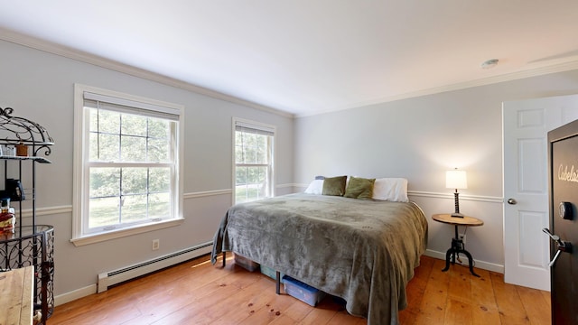 471 Owls Nest Rd, Shapleigh, ME 04076 - bedroom featuring a baseboard radiator, light wood-type flooring, crown molding, and baseboards