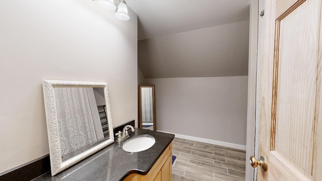 471 Owls Nest Rd, Shapleigh, ME 04076 - bathroom with vanity, wood finished floors, lofted ceiling, and baseboards