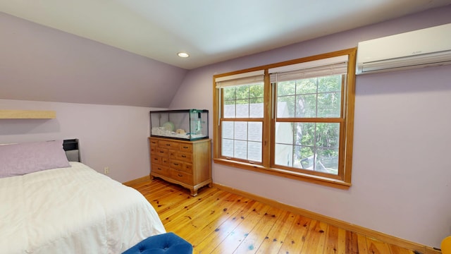 471 Owls Nest Rd, Shapleigh, ME 04076 - bedroom featuring a wall mounted air conditioner, baseboards, vaulted ceiling, light wood finished floors, and recessed lighting