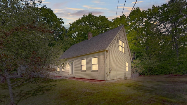 471 Owls Nest Rd, Shapleigh, ME 04076 - view of property exterior with a chimney, a shingled roof, and a lawn