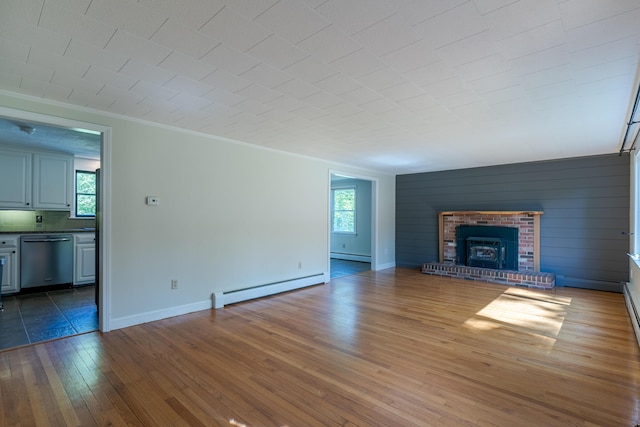 110 Elm St, North Berwick, ME 03906 - unfurnished living room with baseboard heating, healthy amount of natural light, wood-type flooring, and crown molding