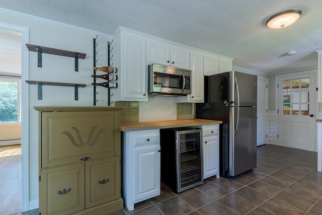 110 Elm St, North Berwick, ME 03906 - kitchen with wine cooler, stainless steel appliances, baseboard heating, wood counters, and white cabinets