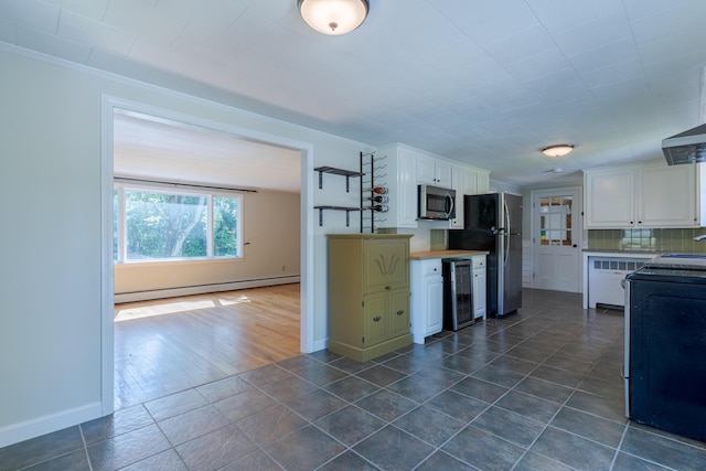 110 Elm St, North Berwick, ME 03906 - kitchen featuring stainless steel appliances, a baseboard radiator, wine cooler, baseboards, and white cabinets