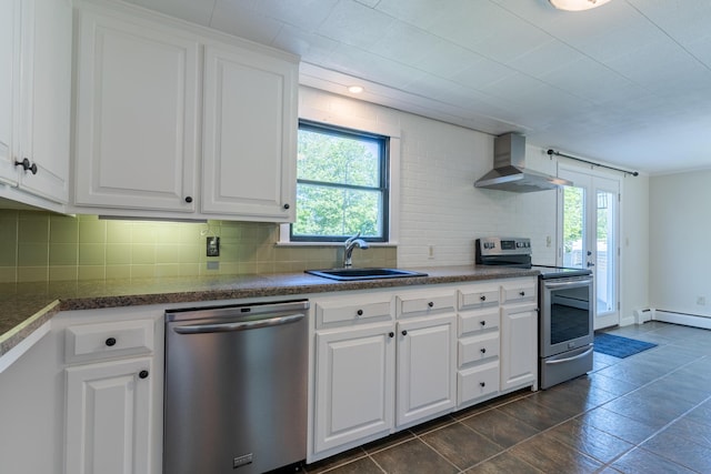 110 Elm St, North Berwick, ME 03906 - kitchen with appliances with stainless steel finishes, a sink, wall chimney range hood, decorative backsplash, and white cabinetry