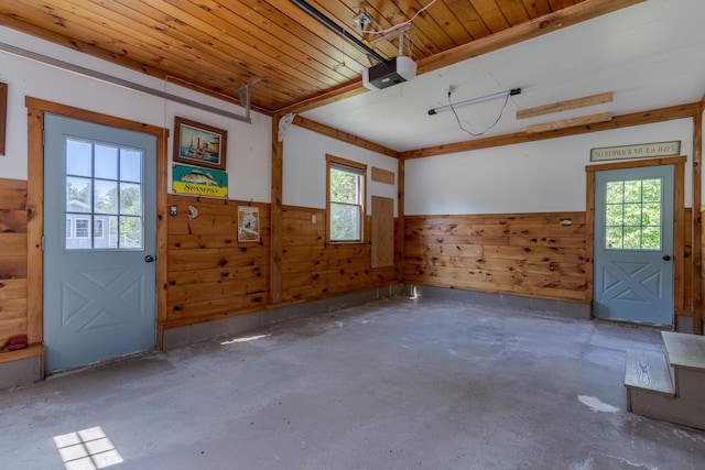 110 Elm St, North Berwick, ME 03906 - garage with wainscoting, wooden walls, a garage door opener, and wooden ceiling