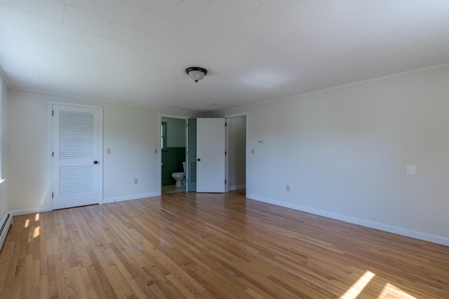 110 Elm St, North Berwick, ME 03906 - spare room with light wood finished floors, baseboards, crown molding, and a baseboard radiator