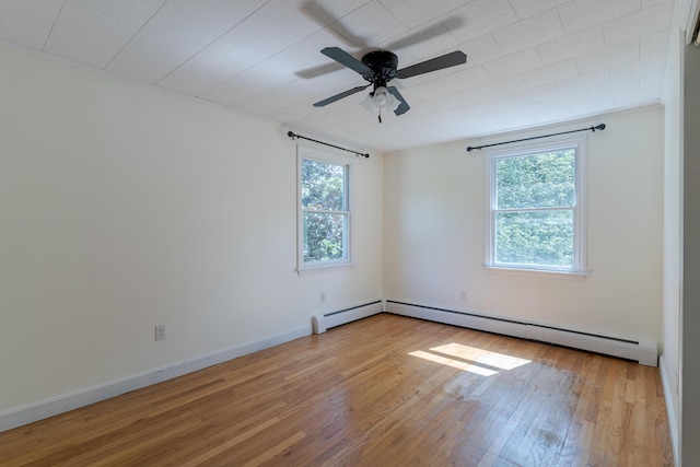 110 Elm St, North Berwick, ME 03906 - spare room featuring wood finished floors, a ceiling fan, a baseboard radiator, and baseboards