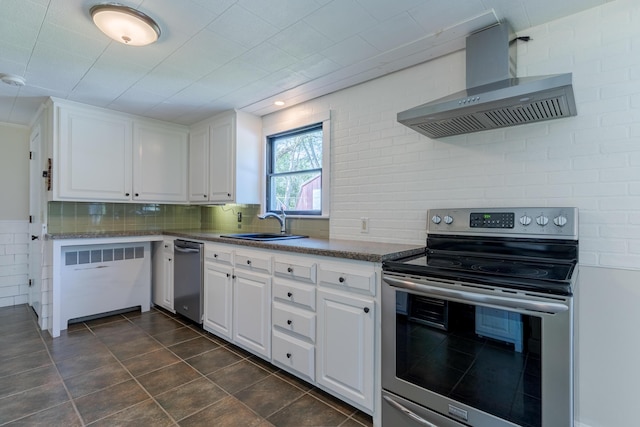110 Elm St, North Berwick, ME 03906 - kitchen with appliances with stainless steel finishes, wall chimney exhaust hood, a sink, white cabinetry, and backsplash