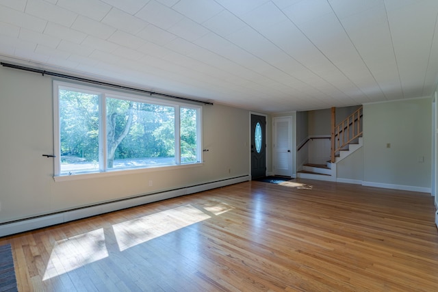 110 Elm St, North Berwick, ME 03906 - unfurnished room featuring a baseboard heating unit, light wood-style floors, stairs, and baseboards