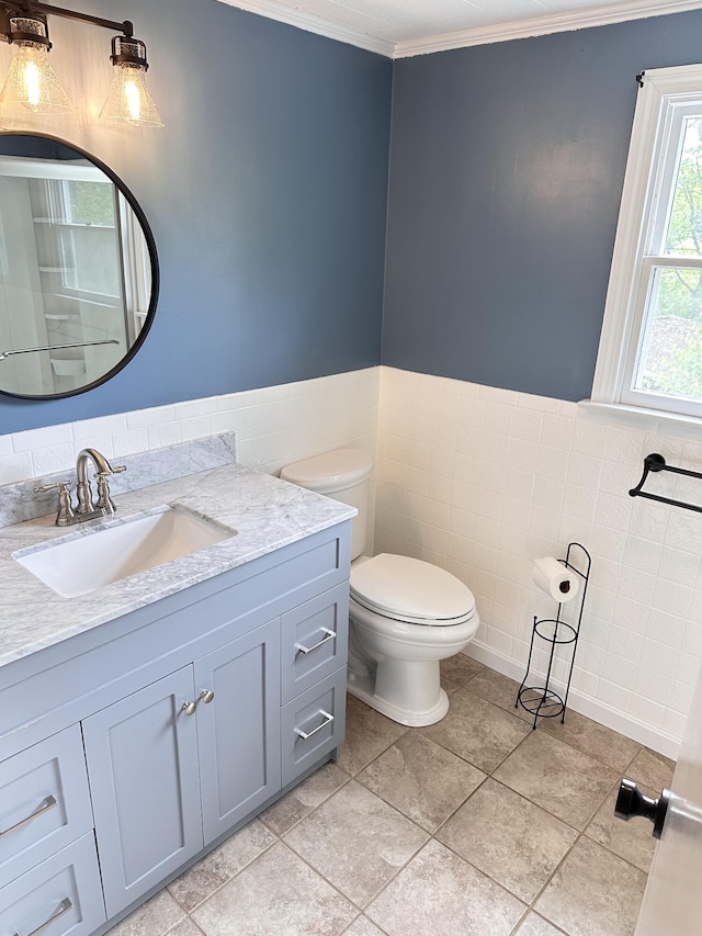 110 Elm St, North Berwick, ME 03906 - bathroom featuring tile walls, crown molding, toilet, vanity, and tile patterned floors